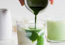 Iced Matcha Latte (4-ingredients!) – Fit Foodie Finds Iced matcha latte in a glass with ice.